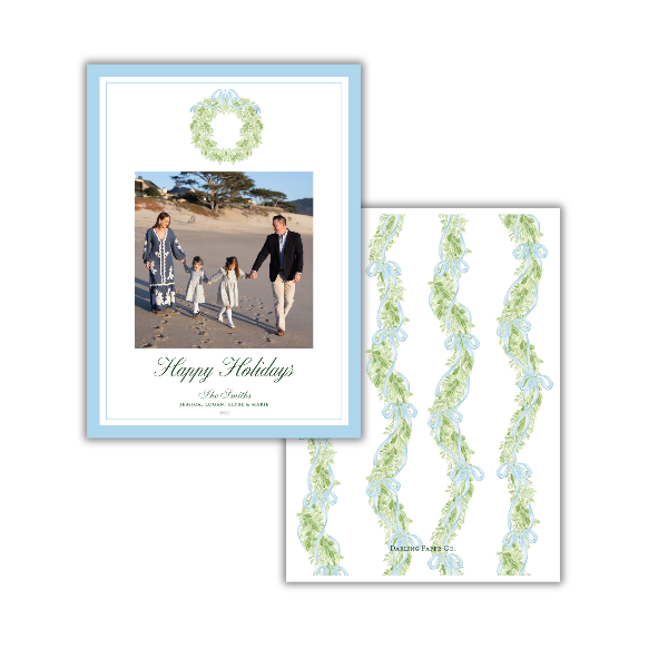 Holiday card with family photo and decorative wreath on a white background